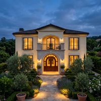A small project thumbnail of a luxury two-storey residence with a cream facade and an arched entrance, lit warmly against an evening sky.